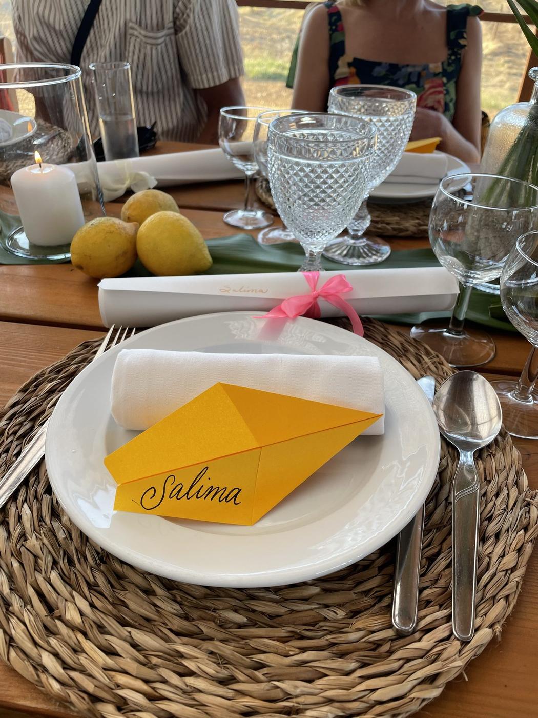Table setting with a hand-lettered place card, lemons, and crystal glassware